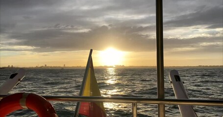 Wall Mural - The flag of Spain on the stern of the yacht against the backdrop of the sea at sunset