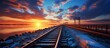 Scenic view of a railway extending over a bridge as the sun sets in the background, creating a beautiful horizon