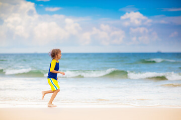 Wall Mural - Kids playing on beach. Children play at sea.