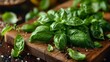   A green basil pile with lemon and pepper on wood cutting boards