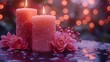   A pair of pink candles resting atop a table alongside a pair of pink blossoms also perched on the table