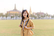 © Jirawatfoto - A Traveler Asian woman in her 30s exploring Wat Pra Kaew. From stunning architecture to friendly locals, she cherishes every moment, capturing it all in her heart and camera for years to come.
