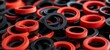 Assortment of red and black rubber gaskets and seals. Industrial components concept for manufacturing and mechanical applications.