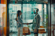© ty - Female and male business partners shake hands at a meeting in an office