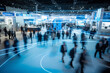 © AspctStyle - Dynamic trade show floor with motion blur of attendees, highlighting the vibrant energy of industry events