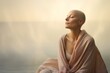 Bald woman in her late 40s, capturing her serene expression and inner beauty. The background features soft, dreamy hues, adding a touch of serenity to the composition