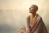 Fototapeta Zwierzęta - Bald woman in her late 40s, capturing her serene expression and inner beauty. The background features soft, dreamy hues, adding a touch of serenity to the composition