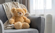 Teddy bear on a soft gray sofa, Generative AI