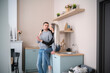 © Mihail - Young smiling Couple Embracing in a Modern Kitchen During a Casual Afternoon