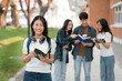 © NINENII - Asian students joining study book, smiling with laptop computer tablet at high school university, college, vacation, summer vacation.