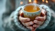 Close-up of hands holding a warm cup, symbolizing heartburn relief through herbal tea, steam rising softly