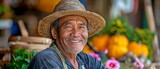 Fototapeta  - picture of a contented, grinning Thai farmer in a Thai countryside.