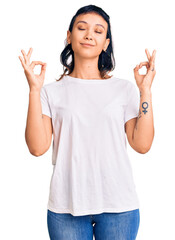 Canvas Print - Young woman wearing casual clothes relax and smiling with eyes closed doing meditation gesture with fingers. yoga concept.