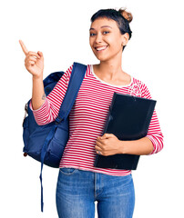 Poster - Young woman wearing student backpack holding binder smiling happy pointing with hand and finger to the side