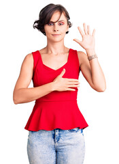 Sticker - Beautiful young woman with short hair wearing casual style with sleeveless shirt swearing with hand on chest and open palm, making a loyalty promise oath