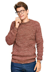 Wall Mural - Handsome caucasian man wearing casual sweater and glasses serious face thinking about question with hand on chin, thoughtful about confusing idea