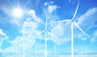 Wind turbines on Blue Sky with Sun Flares. Series of turbines tilt upwards towards the clear blue sky, where the sun shines brightly casting a flare. Perfect day for harnessing wind energy.