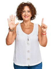 Sticker - Beautiful middle age mature woman wearing casual white shirt showing and pointing up with fingers number six while smiling confident and happy.