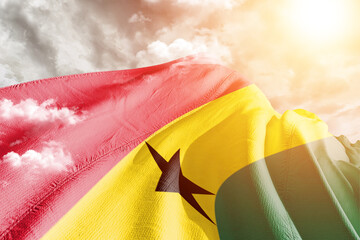 Wall Mural - Ghana national flag cloth fabric waving on beautiful cloudy Background.