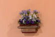 elegant floral arrangement on a vintage shelf against a peach wall