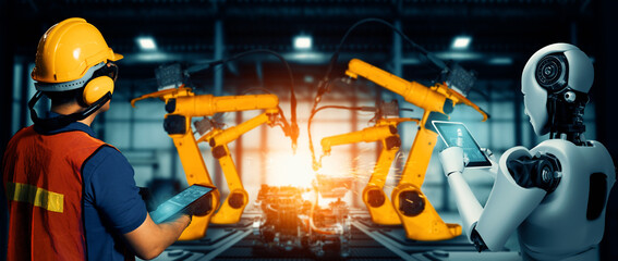 Wall Mural - XAI Mechanized industry robot and human worker working together in future factory. Concept of artificial intelligence for industrial revolution and automation manufacturing process.