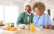 Mature Couple On Vacation Or At Home Eating Breakfast Together