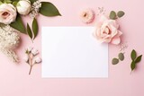 Fototapeta Kwiaty - A flat lay composition featuring a blank card surrounded by an assortment of flowers on a pink background. Flat Lay with Flowers and Blank Card