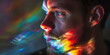 A young man's profile is cast in vibrant rainbow hues against a dark background, creating a visual enigma
