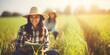 Two smiling women students in hats studying in a lush green field, enjoying the sunshine and the tranquility of the rural setting, embodying a connection with nature