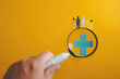 hand holding magnifying glass icon healthcare icon medical icon. Health insurance health concept.