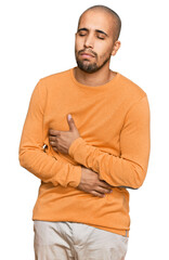 Poster - Hispanic adult man wearing casual winter sweater with hand on stomach because nausea, painful disease feeling unwell. ache concept.