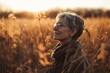 Portrait of a happy senior woman in the field at sunset.