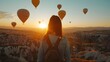 Girl Traveler Explores Breathtaking Cappadocia Landscape with Hot Air Balloons at Sunrise in Goreme,Turkey