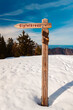 Alpine winter view with a wooden signpost at Mount Predigtstuhl, Bad Reichenhall, Berchtesgadener Land, Bavaria, Germany