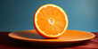 A fresh orange half, showcasing its pulpy texture and rich color on a black surface.