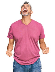 Canvas Print - Middle age grey-haired man wearing casual clothes angry and mad screaming frustrated and furious, shouting with anger. rage and aggressive concept.