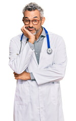 Sticker - Middle age grey-haired man wearing doctor uniform and stethoscope thinking looking tired and bored with depression problems with crossed arms.