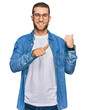 © Krakenimages.com - Young caucasian man wearing casual clothes pointing to the back behind with hand and thumbs up, smiling confident