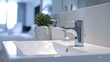 Close-up sink with faucet with running water in bright bathroom