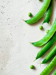 Poster - Bright green sugar snap peas arranged on a white textured background with space for text.