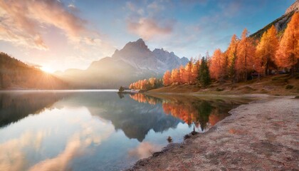 Canvas Print - first sunlight glowing hills of federa lake spectacular sunrise in dolomite alps with orange larch trees on the shore colorful morning scene of italy europe beauty of nature concept background