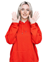 Sticker - Young blonde girl wearing casual clothes showing and pointing up with fingers number nine while smiling confident and happy.