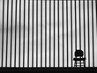 Solitude Confined. The Chair Behind Metal Bars. Minimalism. Black and white. Monochrome.
