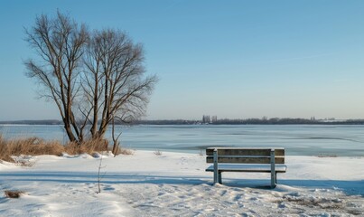 Wall Mural - A snow-covered bench overlooking the frozen expanse of a lake