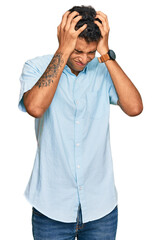 Wall Mural - Young handsome african american man wearing casual clothes suffering from headache desperate and stressed because pain and migraine. hands on head.