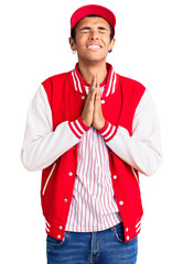 Wall Mural - Young african amercian man wearing baseball uniform begging and praying with hands together with hope expression on face very emotional and worried. begging.