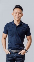 Wall Mural - A handsome chinese man, standing, wearing a black polo shirt, with hand in the pocket