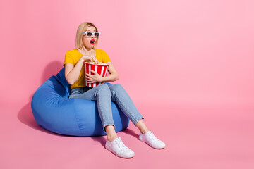 Wall Mural - Full length photo of excited impressed lady dressed yellow t-shirt eating pop corn watch movie empty space isolated pink color background