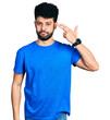 © Krakenimages.com - Young arab man with beard wearing casual blue t shirt shooting and killing oneself pointing hand and fingers to head like gun, suicide gesture.