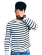 © Krakenimages.com - Young arab man with beard wearing casual striped sweater covering eyes with hand, looking serious and sad. sightless, hiding and rejection concept